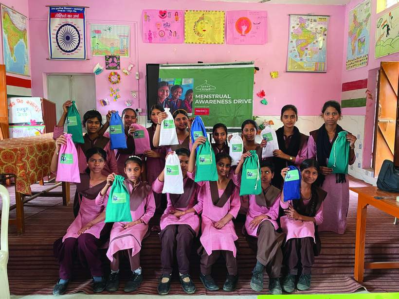 Students at a menstrual awareness drive holding their Sakhi kits